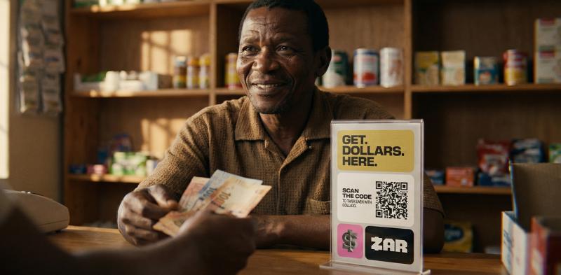 Merchant exchanging cash for digital dollars via ZAR QR code